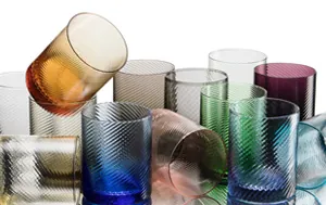Collection of coloured textured glass tumblers in blue, green, amber and grey tones.
