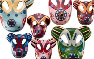 Collection of five colourful decorative animal face masks in ceramic with bold painted patterns.