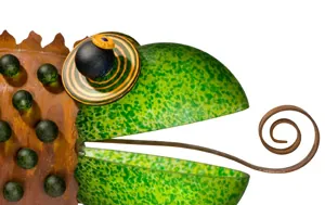 Close-up of a decorative metal chameleon figurine in green with rustic copper detailing.